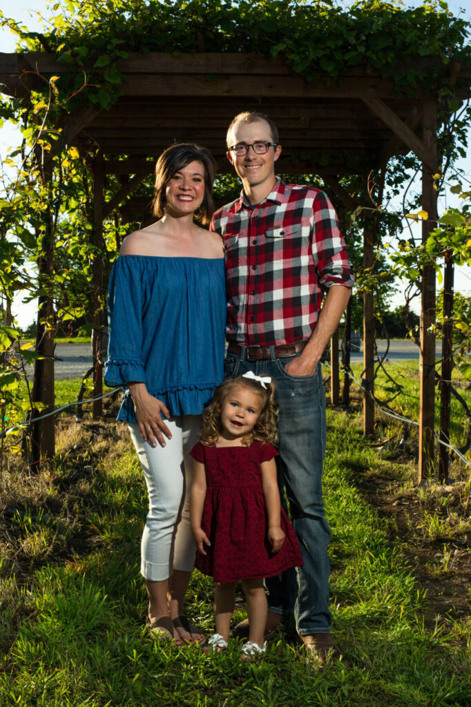 man with his wife and daughter in field